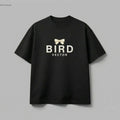 Cream ribbon bow graphic on a black t-shirt. 180gsm organic ringspun cotton featuring BIRD VECTOR minimalist text branding.