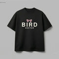 Mauve ribbon bow graphic on a black t-shirt 180gsm organic ringspun cotton featuring BIRD VECTOR minimalist text branding.